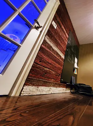A home office with a reclaimed wood accent wall.