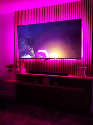 Custom LED installation behind a TV accent wall, creating an immersive ambiance.