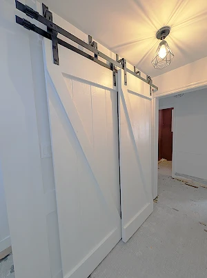 A modern farmhouse style barn door with a professional finish.