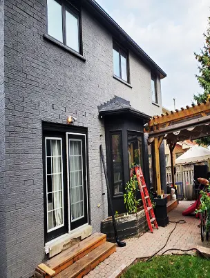 A full home exterior transformed with modern grey brick stain.