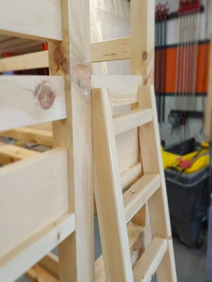 A bunk bed frame being assembled in the workshop