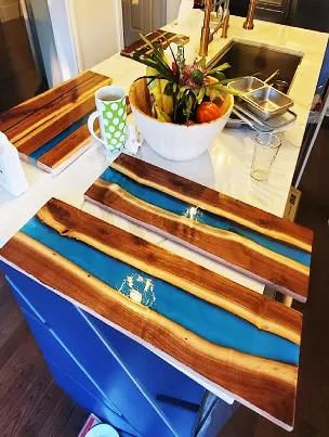 Close-up of a handcrafted charcuterie board showing the smooth, food-safe finish on the wood.