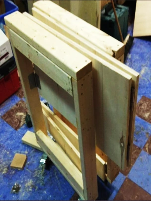 A lightweight collapsible cart shown from the side, highlighting its solid softwood construction.