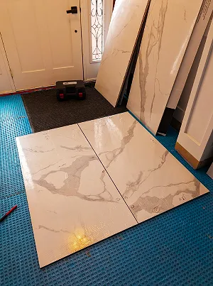 Precision tile setting with large-format porcelain tiles.