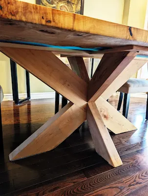 A custom fabricated sculptural wood base for a dining table