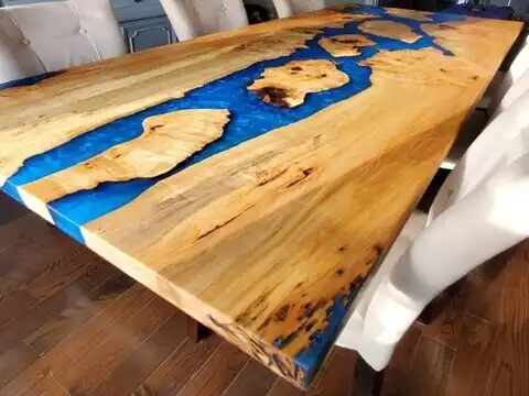 Epoxy river dining table made from maple burl