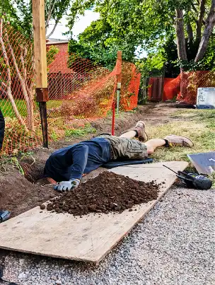 A deep concrete footing for a fence post.