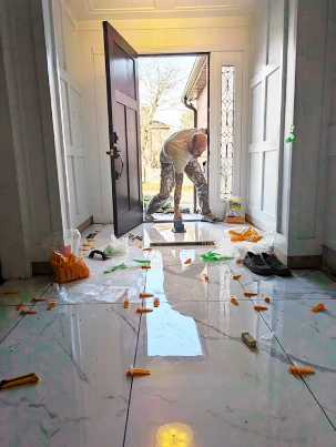 Large-format porcelain tiling in a grand foyer.