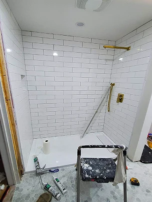 A custom shower with subway and hex tile.