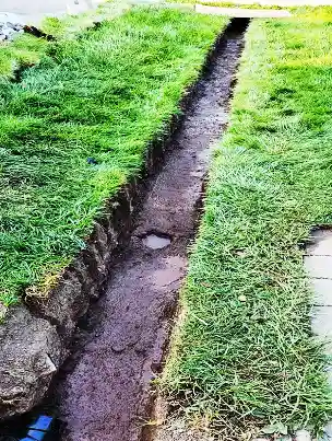 High-flow geotextile fabric and perforated pipe for a French drain.