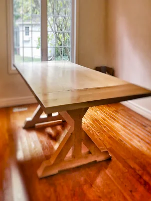 A classic trestle-style dining table made from Hard Maple