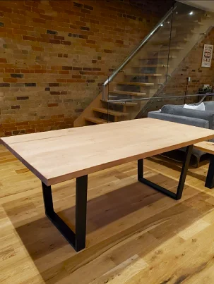 A modern Hard Maple table with a steel base