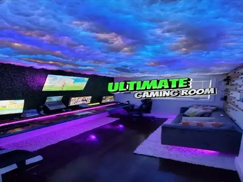 Immersive gaming room with custom desk and accent walls