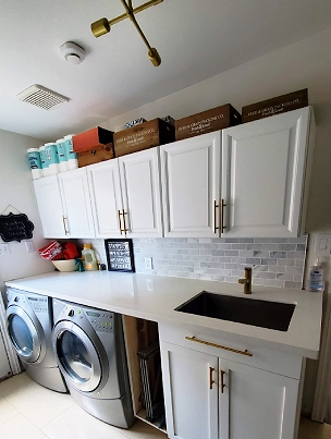A well-organized and stylish laundry room with custom cabinetry.