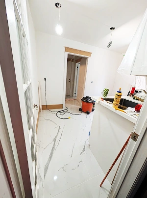 A laundry room with custom white cabinetry and a dark countertop.