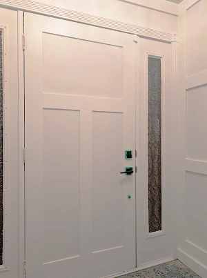 Custom architectural trim around a modern interior door.