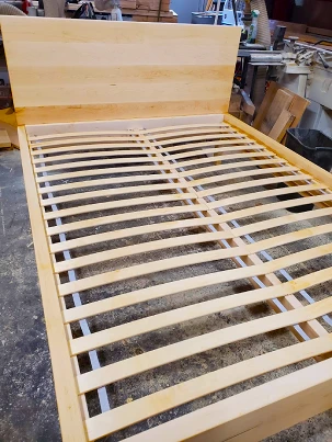 A custom-stained solid wood platform bed