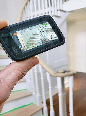 Refinished wooden staircase with painted risers and dark wood treads in Oakville home.